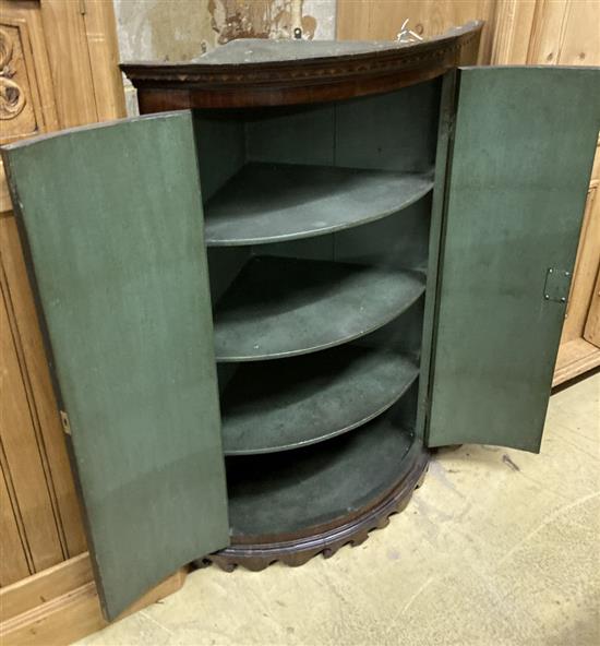 A George III mahogany corner bow front hanging corner cabinet, width 70cm, depth 50cm, height 107cm